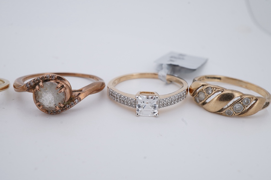 Six gem-set rings, comprising: one set with brilliant-cut diamonds; four set with colourless simulant diamonds; and one set with circular-cut peridots, each mounted in 9ct gold, British hallmarks, combined gross weight a
